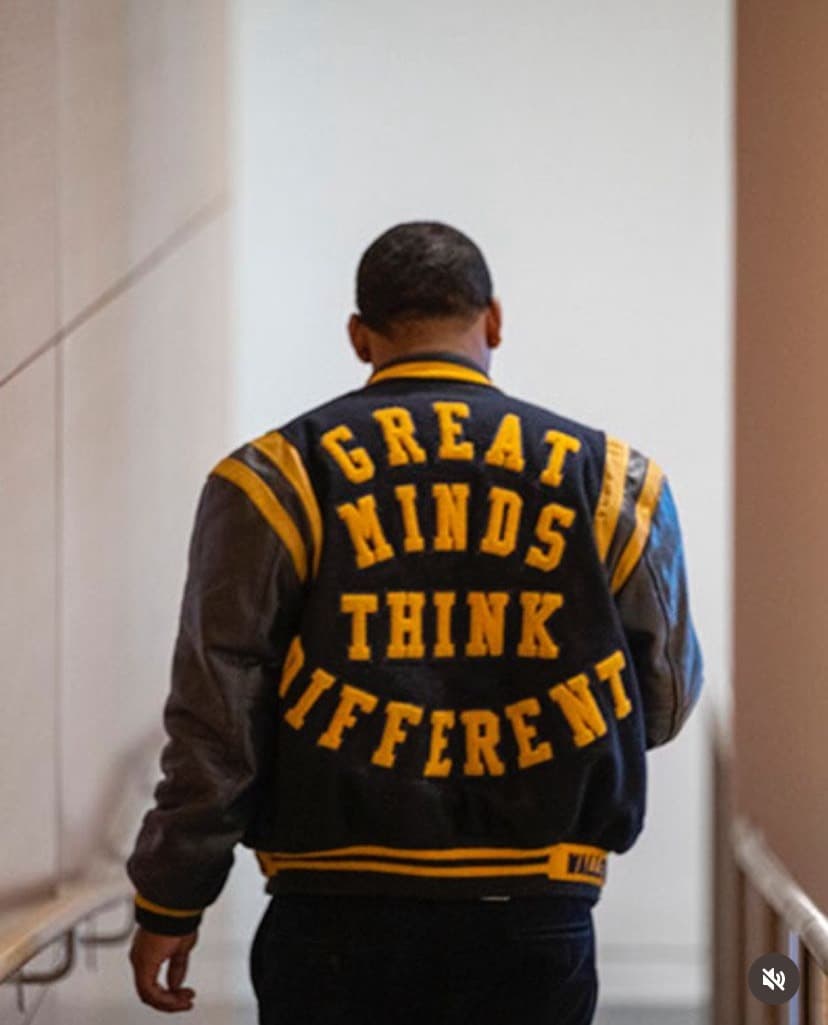 Wesley wearing a Great Minds Think Different varsity jacket