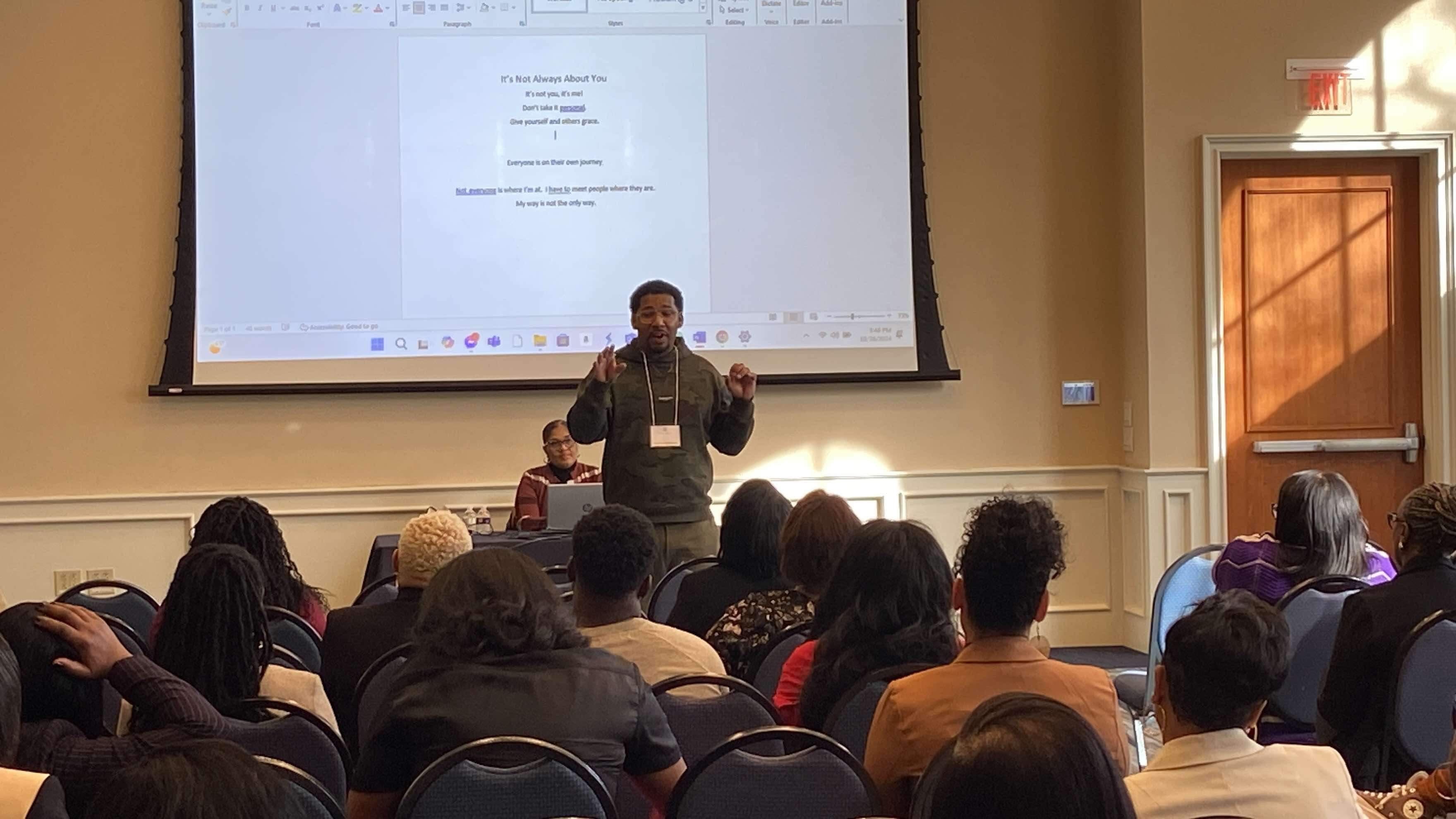 Wesley Robinson facilitating a Poetry Clinic for a seated audience